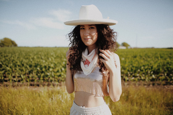 woman wearing cowboy hat and bandana